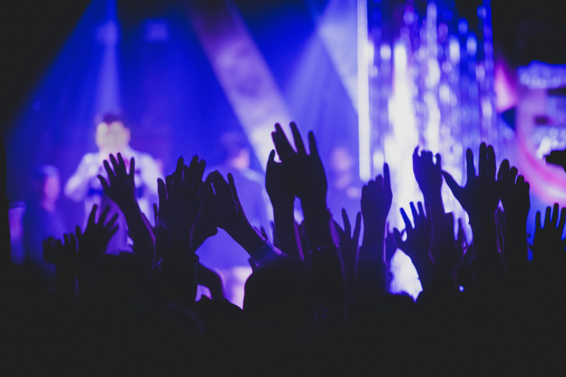 Vibrant music concert scene with crowd and colorful stage lights.